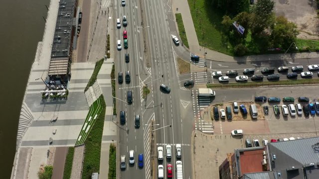 Drone flight over the freeway highway in the old city of Warsaw, freeway and bridge connecting together. Highway with traffic near the river hung in the capital of Poland, Warsaw.
