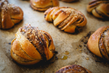 Top close-up view of homemade Swedish cardamom and cinnamon rolls. Landscape format.