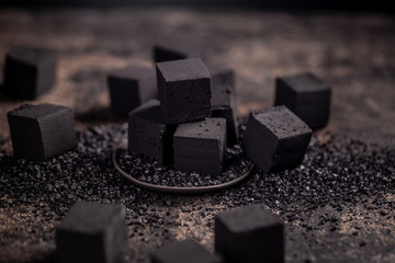 Charcoal for hookah on the old rustic wood table