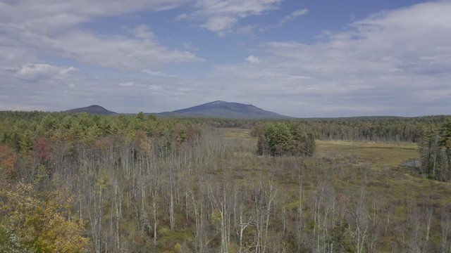 Mount Monadnock mountain in Southern NH, aerial view drone flying over wetlands during fall day