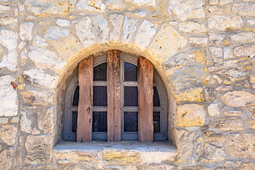 Fototapeta na wymiar Arched window on stone building