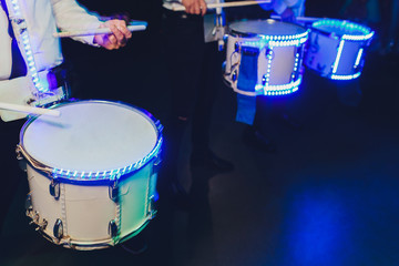 Unrecognizable man marching while playing drumming on drum.