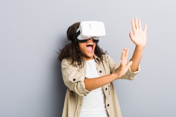 Young african american woman using a virtual reality glasses