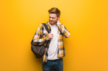 Young redhead student man suffering neck pain