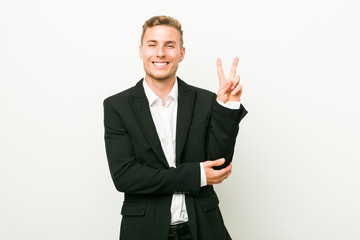 Young caucasian business man showing number two with fingers.