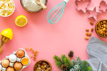 Cooking for Christmas or New Year dinner. Ingredients and utensil on pink background top view space for text