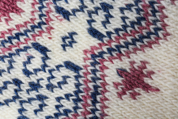 Knitted soft woolen sock as background, closeup