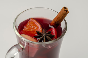 Cup with red mulled wine on white background, top view