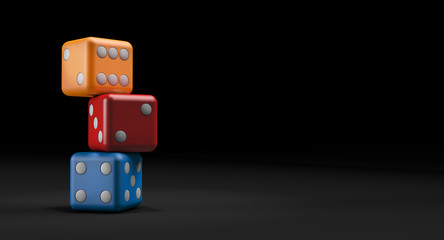 Three colored game dice. Dark background