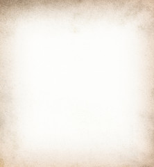 Old vintage paper with a glowing center and grunge vignette.