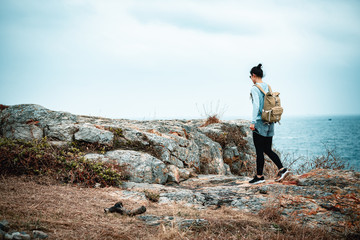 Young asian woman hiking at seaside mountain
