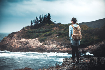 Young asian woman hiking at seaside mountain