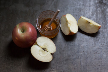 Rosh Hashanah apples with honey on natural rustic table minimal