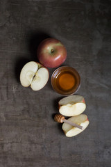 Rosh Hashanah apples with honey on natural rustic table minimal