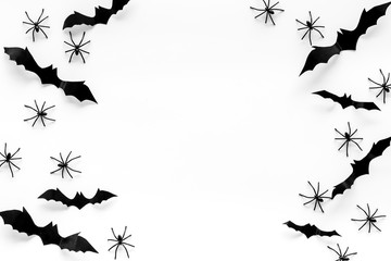 Stylish Halloween design. Bats and spiders on white background top view copy space frame