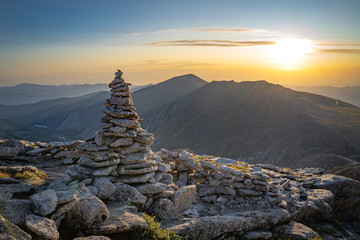 mountain cairn at sunrise - Powered by Adobe