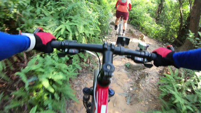 Cross country biking cyclists riding bike on tropical rainforest trail ,fell off bike on rough road