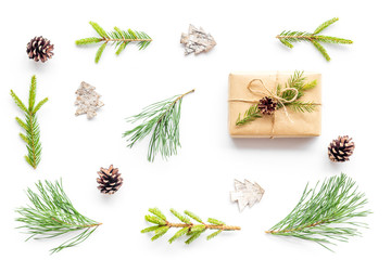 Winter festive layout with spruce branches and New Year presents on white background top view flat lay