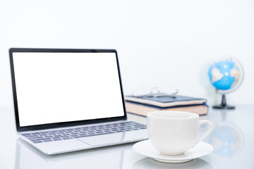 Laptop mockup and coffee cup on table