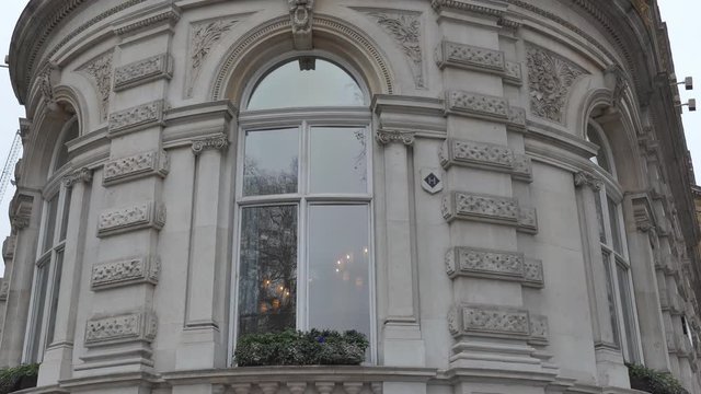 Tilt shot of a semi circular building with big windows.