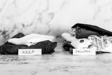 declutter and tidying up fashion clothes stacked into Keep and Declutter piles with text