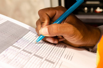 close-up of technician fill the maintenance form,Engineer write data in maintenance check list....