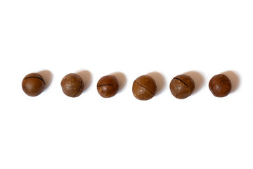 Pattern of nuts- inshell macadamia nut on a white background. Concepts about decoration, healthy eating and food background.