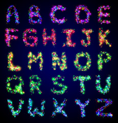  English alphabet from a multi-colored electric garland on a black isolated background. 