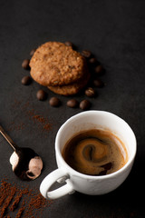 cup of coffee and cookies on wooden table