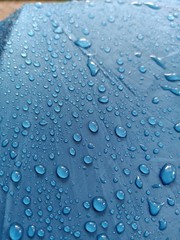 water drops on blue background on umbrella