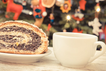 Vintage photo, Traditional poppy seeds cake, coffee or tea and christmas tree with decoration