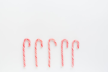 Christmas composition. lollipop canes on white background. new year concept. Greeting card, winter holidays, xmas celebration 2020. Flat lay, top view, copy space, mockup, template