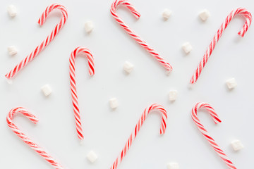Christmas composition. lollipop canes and marshmallows on white background. new year concept. Greeting card, winter holidays, xmas celebration 2020. Flat lay, top view, copy space, mockup, template