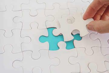 Hands with jigsaw puzzle pieces, Business strategy planning, Alzheimer's disease,  Autism and...