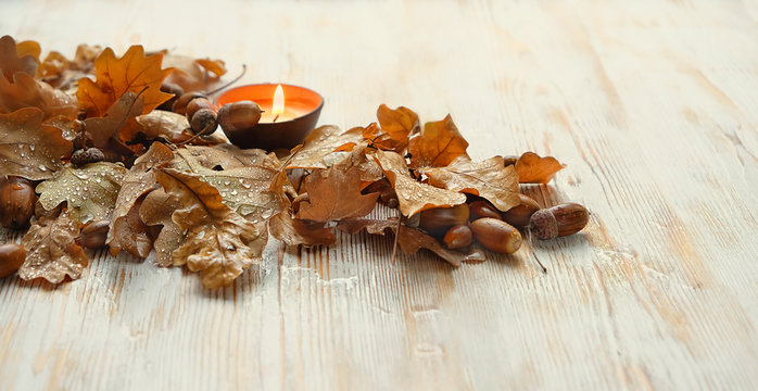 candle latern and autumnal oak leaves. Fall atmosphere mood composition, concept of thanksgiving, halloween, autumnal equinox, mabon. Seasonal autumn background. copy space