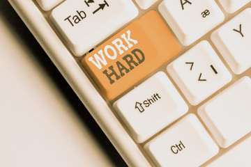 Writing note showing Work Hard. Business concept for Laboring that puts effort into doing and...
