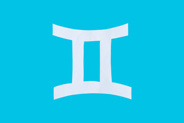 paper cut horoscope sign Gemini isolated on a blue background