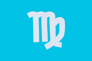paper cut horoscope sign Virgo isolated on a blue background