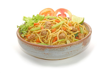 Noodles isolated on white background. Vegetarian stir fried noodle with tofu, carrots and green vegetables. Chinese vegetarian noodle for vegetarian festival.