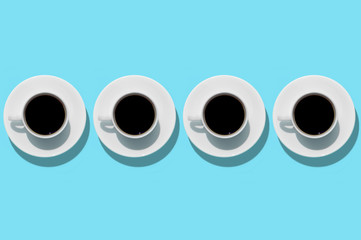 Cups with coffee on aquamarine background. Isolated. Top view.