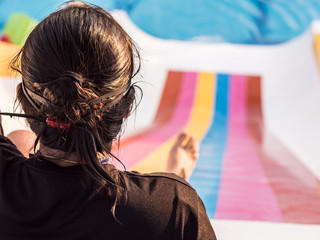 Girl is playing  slider at the water park.
