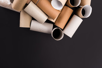 Empty Toilet Rolls Stack Up On a Black Background