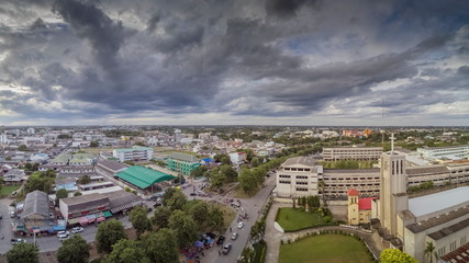 Aerial view evening above city with raining and storm in the sky background, sunset with rain storm at Ban Pong City, Ratchaburi, Thailand.
