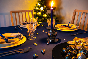 Christmas table setting with christmas tree in background