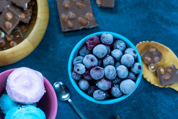  ice cream on a dark background with berries and chocolate