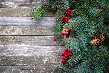 New Year. Christmas. Wooden background and fir branches, cones, copyspace.