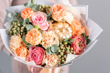 Beautiful bouquet of mixed flowers in womans hands. the work of the florist at a flower shop. Fresh cut flower.