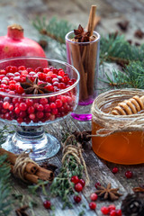 Warm cranberry tea with honey and pomegranate. Wood background.
