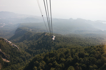 Mountain views from the cable car cabin to the top of Tahtali and the sea near the coast of Kemer, Antalya, Turkey