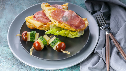 Food banner: Delicious sandwiches, snacks, fast food, flour product. Bread pieces with stuffing. Breakfast on black plate.